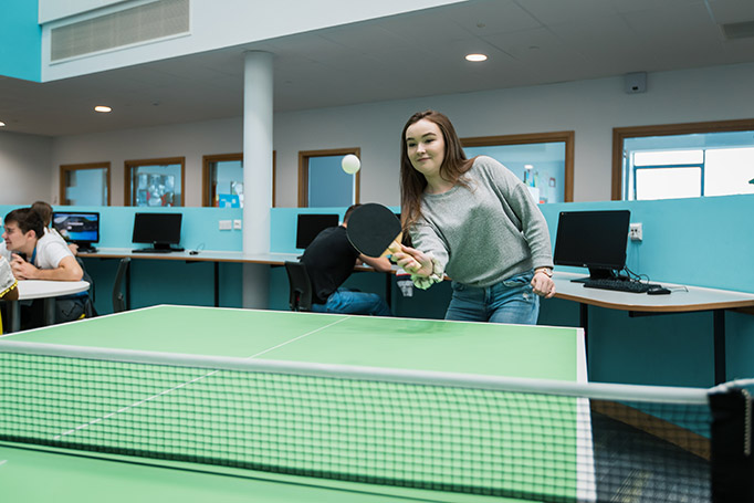 A Deeside Sixth Form student playing table tennis on the first floor