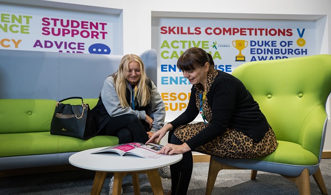 a student in Yale speaking with a member of staff in the student services team, showing the full time guide