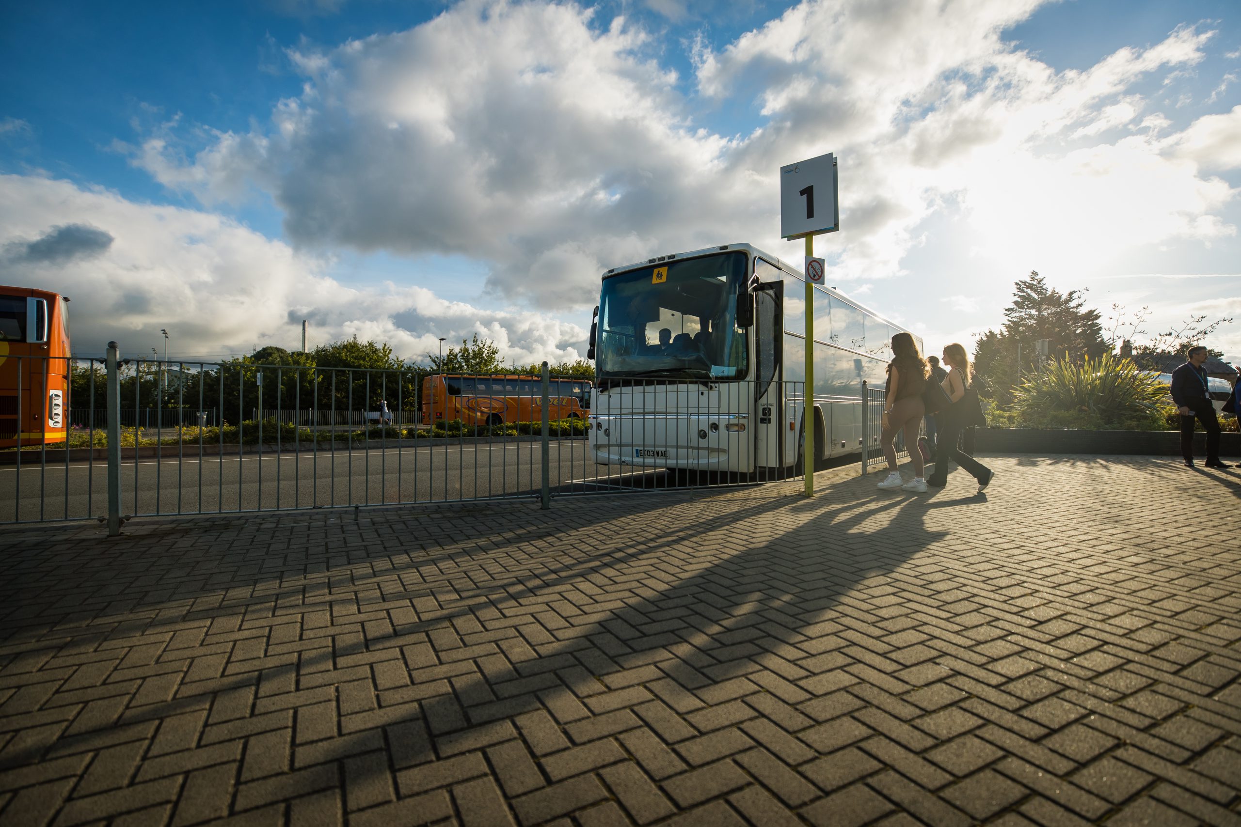 One of the buses at Deeside Sixth form with students entering to go home