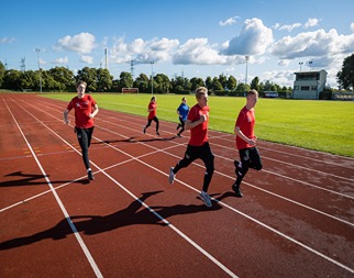 A set of sport students racing on the Deeside running track