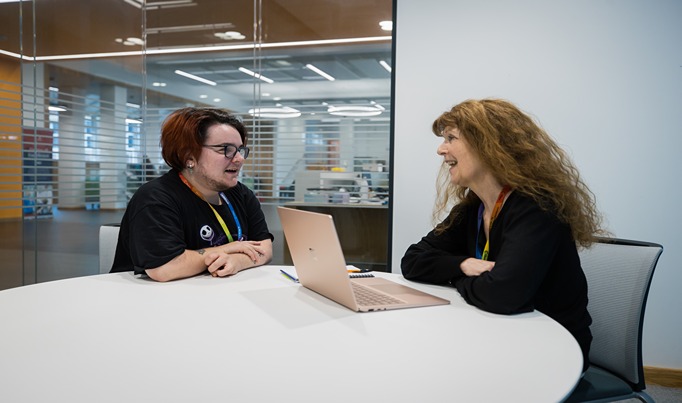 A student in a private meeting pod in Deeside speaking with a member of staff