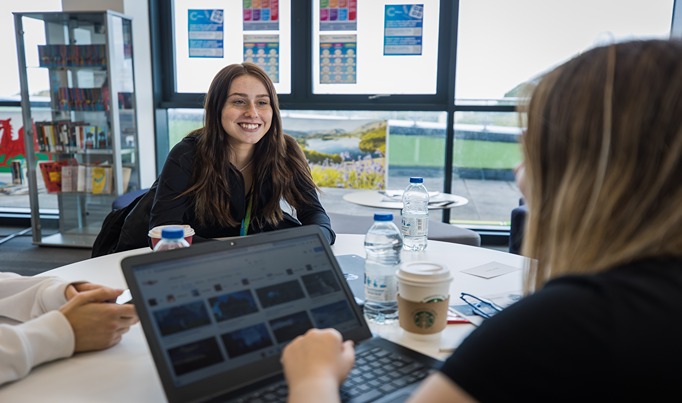 A student in Deeside Sixth speaking with a member of staff