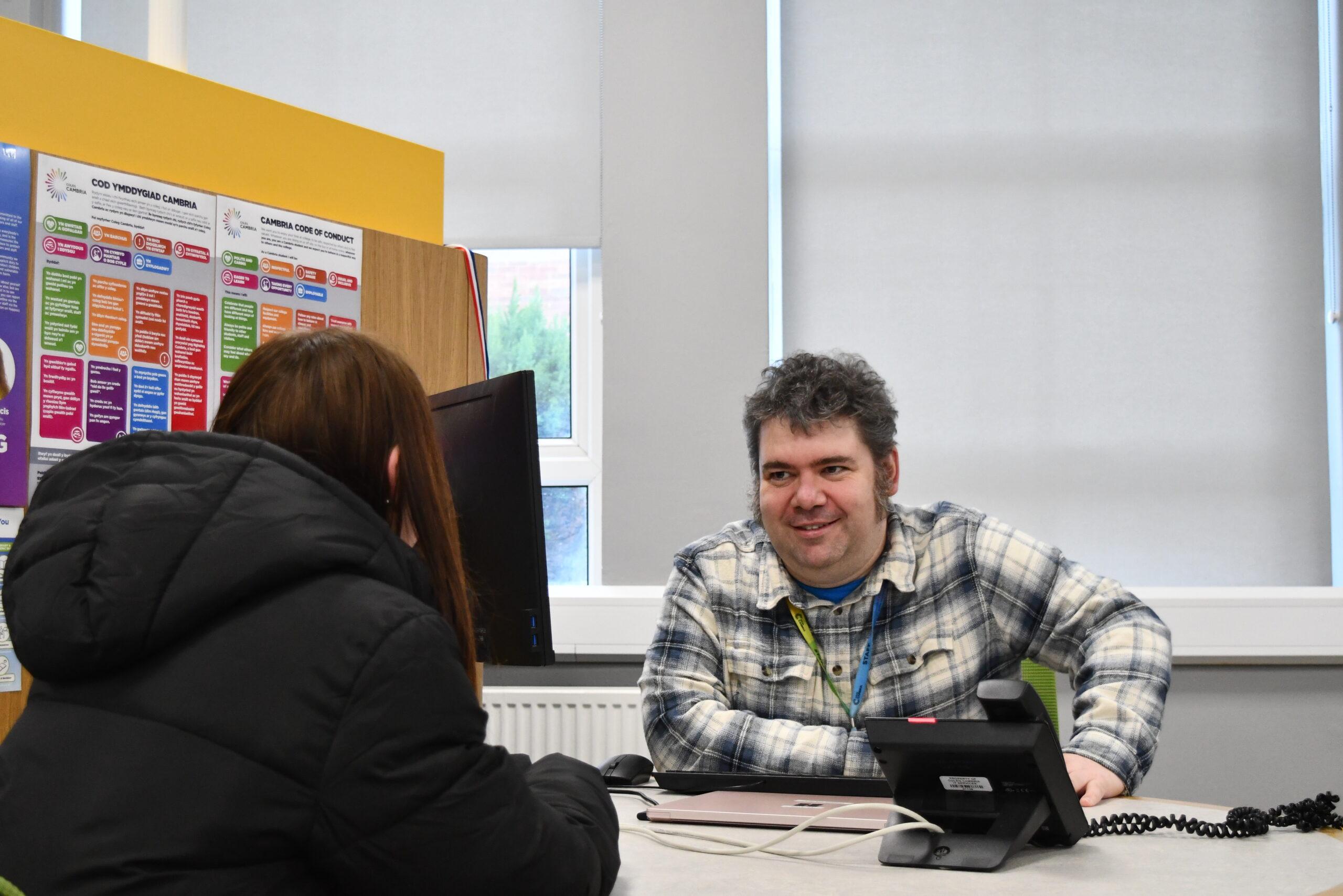 Student Services and Careers Advisor Christopher Fazey speaking with a student
