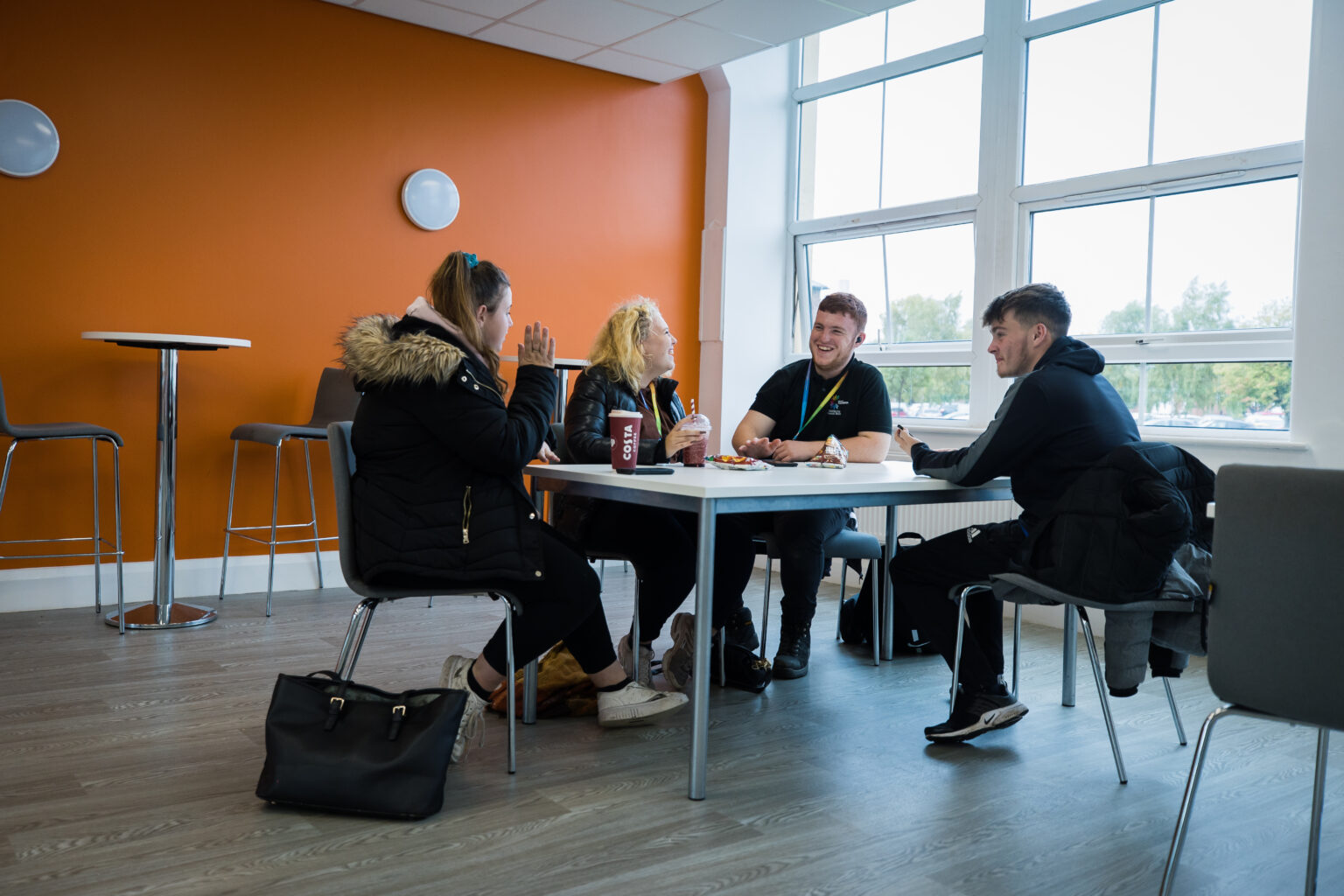 learners sat around a table with drinks