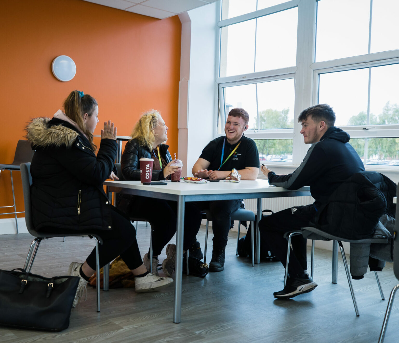 learners sat around a table with drinks
