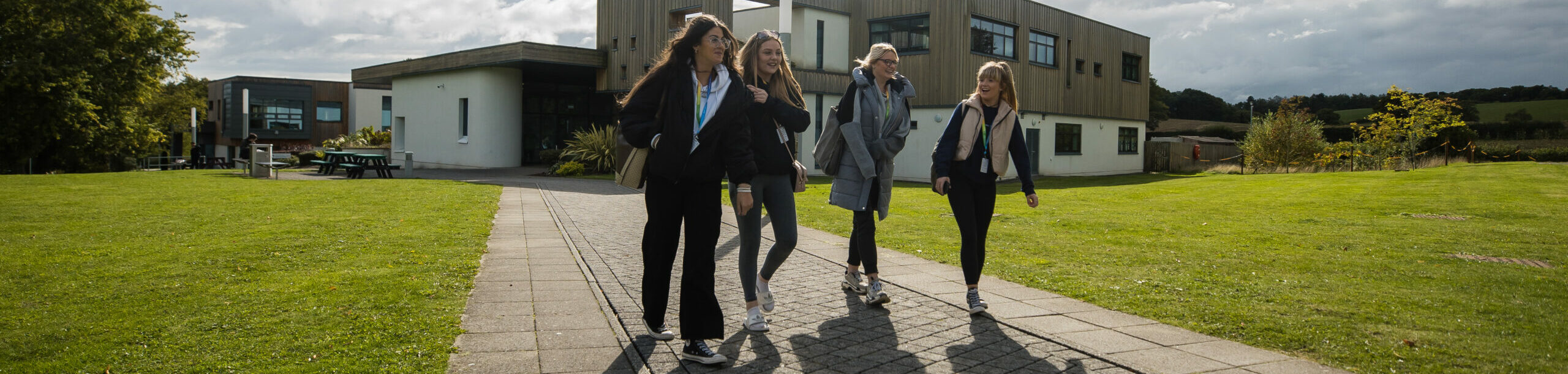 four learners walking outside Northop