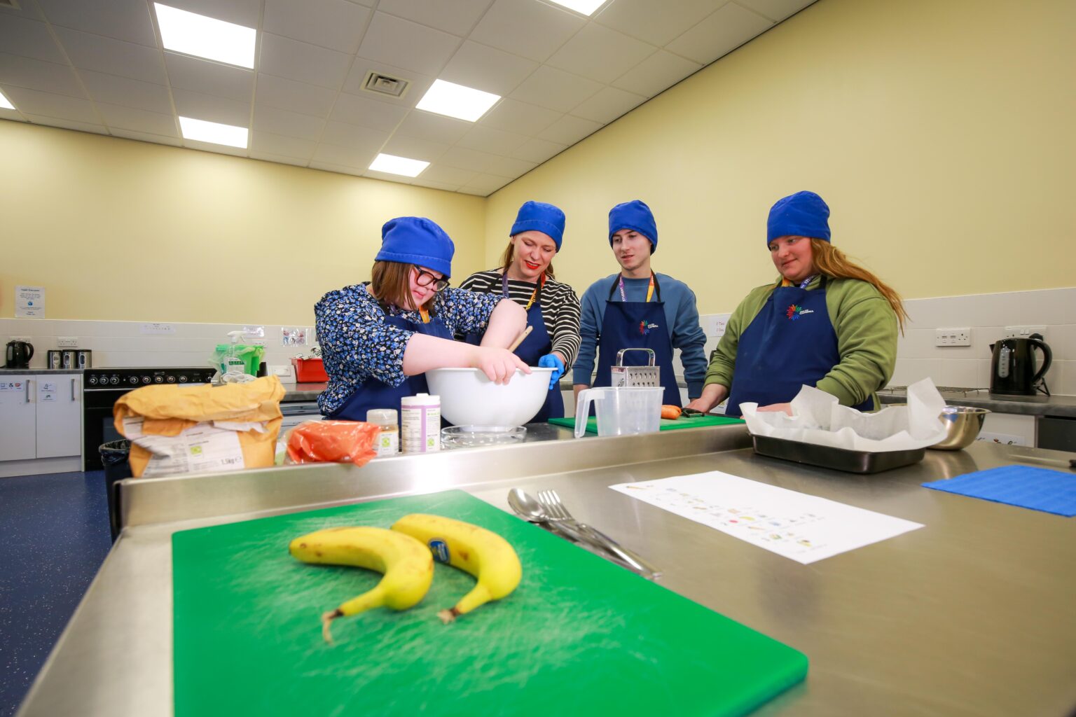 four learners in the ILS centre baking