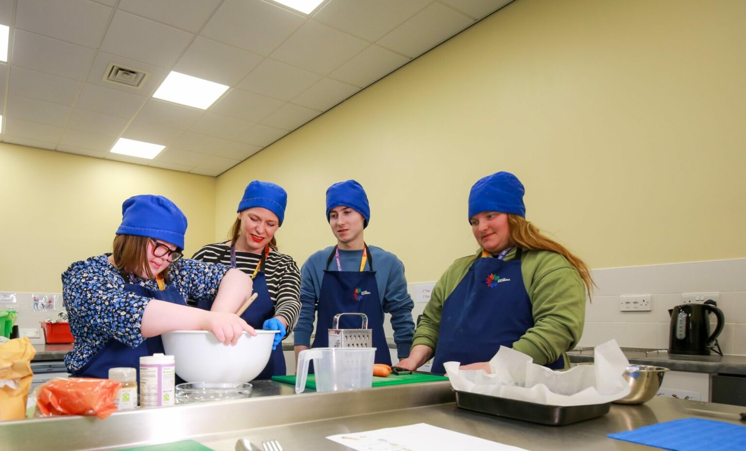 four learners in the ILS centre baking
