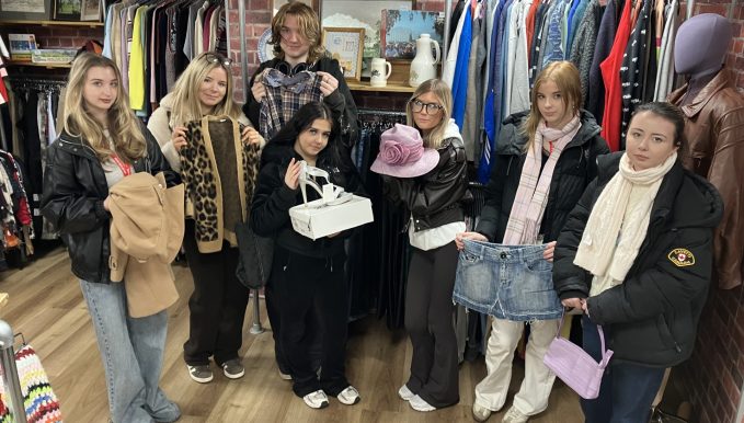 Seven of the 11 students who will run the pop-up shop present some of their favourite finds at Chester’s Hope House store