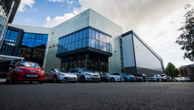 The new Hafod building from the outside with a row of cars in front